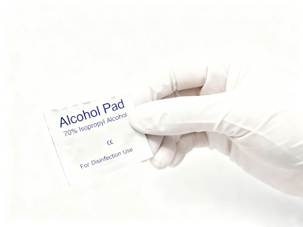 shevenmed pad in gloved hand 1 Close-up of a Shevenmed alcohol pad being held by a gloved hand, showing proper handling